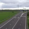 At the other side of the bridge, the same sliproad has grown two more lanes and splits to form two separate sliproads. These outer carriageways, connecting to the A580, are technically the mainline of the M61, while the wider motorway in the centre is just considered to be linking sliproads to the M60.
