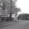   Bridge 115 under construction, with the road diverted temporarily around the outside. Note the contractor's sign on the left — "London — Yorkshire Motorway/Laing/Bridge no. 115". Believe it or not, this road is the A45. 31 October 1958.