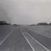 Looking north from bridge 79, north of what is now junction 15a, at the virtually complete motorway. One line of road markings are still to be painted. 18 August 1959.